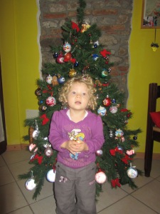 Michelle in front of her Christmas tree